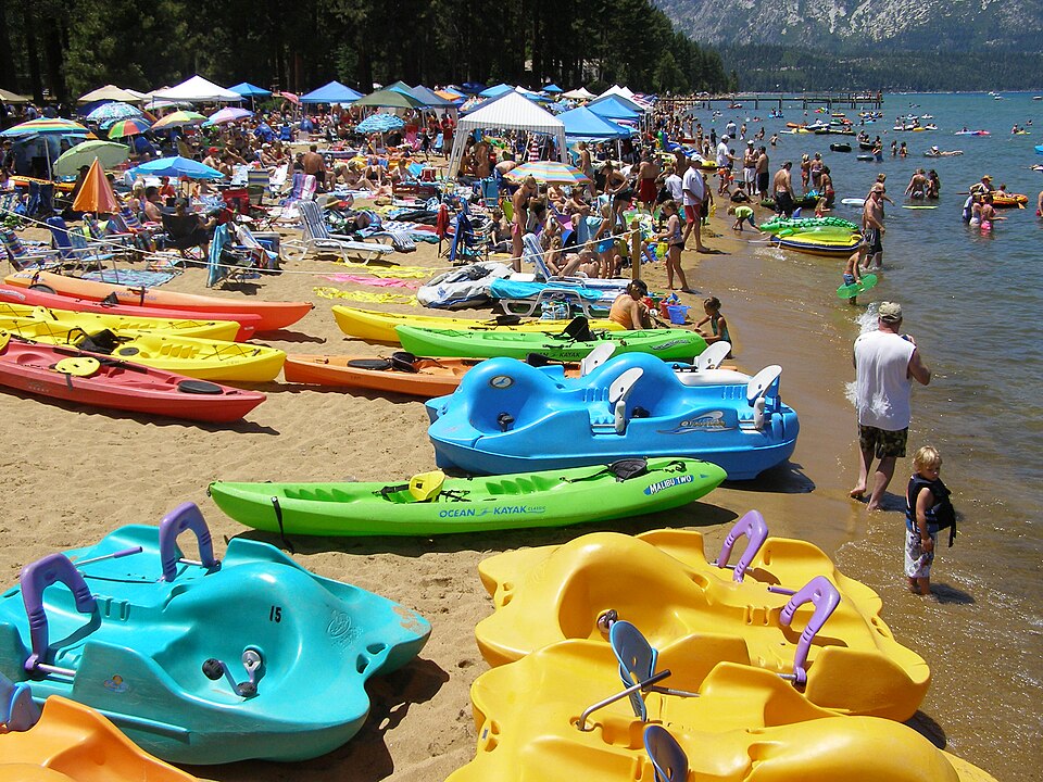 Families and colorful paddle boats at Camp Richardson Beach on Lake Tahoe, photographed in 2008.