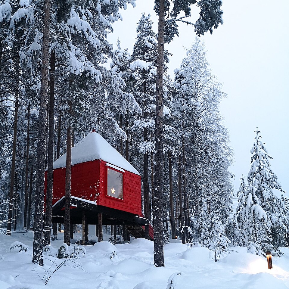 The red Blue Cone treeroom at Treehotel in snowy Harads, Sweden, photographed in 2019.